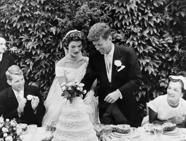 12 Sep 1953, Newport, Aquidneck Island, Rhode Island, USA --- Original caption: John F. Kennedy and Jacqueline Bouvier cutting their wedding cake after their marriage in Newport, Rhode Island. John Kennedy was then U.S. Senator from Massachusetts. Robert Kennedy at left. --- Image by © Bettmann/CORBIS